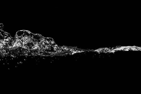 close up of water waves splash and bubbles isolated on black background.の写真素材