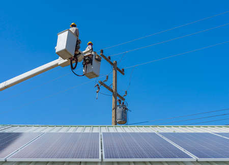 maintenance of electricians work with high voltage electricity on the hydraulic bucket