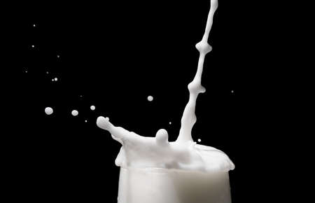 white milk splash on dark backgroundの写真素材