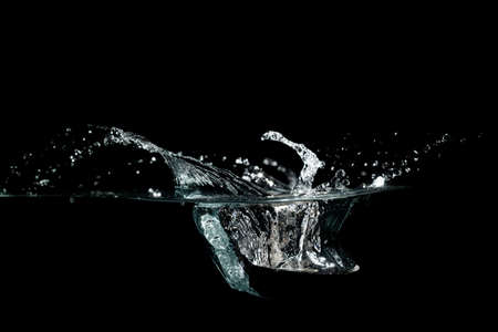 close up of water waves splash and bubbles isolated on black background.の写真素材