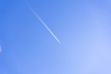 clear blue sky background with a plane. tone blue background. tone blue wallpaper.