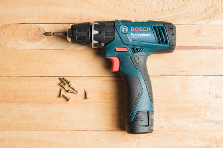 Ubon Ratchathani, Thailand -June 19,2019:Bosch power electric drill generation GSB 120 LI in isolated on white background, Close-up hand holding electric drill in isolated white backgroundのeditorial素材