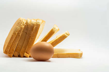 Egg and sliced âbread on a white background.の写真素材