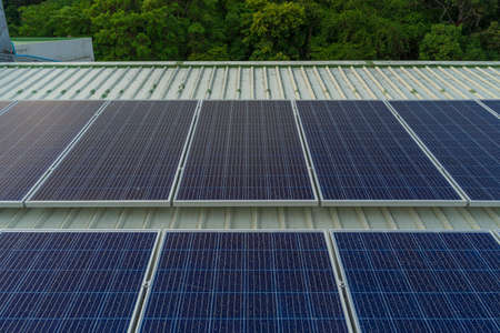 solar cells panel installed on the roof of a large building are full of dirt and dust.の写真素材