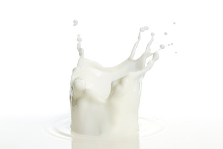 pouring of milk splash isolated white backgroundの写真素材