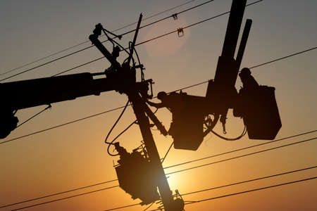 Electricians install equipment in the high-voltage system.
