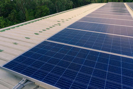 solar cells panel installed on the roof of a large building are full of dirt and dust.