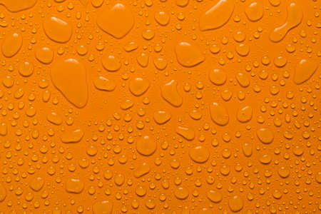 close-up water drop orange backgroundの写真素材