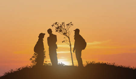silhouette of group of people standing on mountain natural backgroundの写真素材