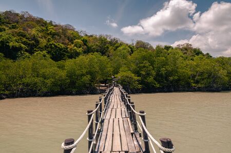 Wooden pier and thai long tail boats in Talet bay at Nakhon Si Thammarat province of Thailand.の写真素材
