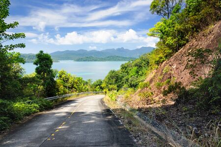 Winding mountain road through rainforest at the coastline of the Koh Chand Island, Thailand.の写真素材