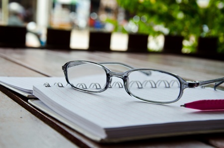 eyeglasses on notebook on table