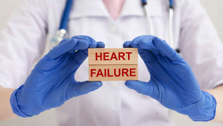 Heart failure concept. HEART FAILURE words inscription on wooden blocks in doctor handsの写真素材