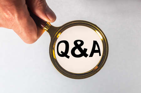 Magnifying glass in male hand, isolated on greyの写真素材