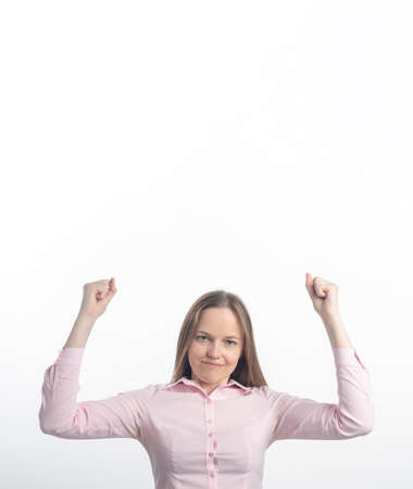 Winning success woman happy ecstatic celebrating being a winner. Dynamic energetic image of Caucasian female model isolated on white background. copy space, vertical bannerの写真素材