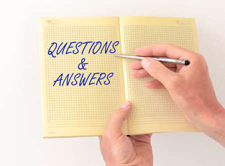 Q and A text word inscription acronym on blocks in hands of doctor. medical questions and answers...
