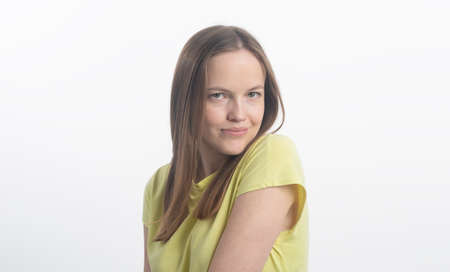young gorgeous brunette model looking gently over the shoulder, flirting, studio shotの写真素材