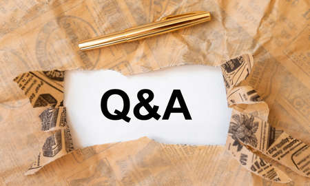 Q and A word acronym on torn craft brown and white paper, questions and answers conceptの写真素材