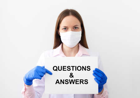 Q and A text word inscription acronym on paperin hands of doctor. medical questions and answers concept, glovesの写真素材