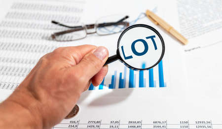 LOT word inscription text, lottery or choice concept, luck concept, financial documents and magnifying glassの写真素材