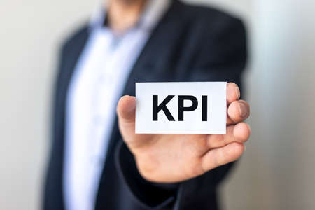 KPI acronym Key Performance Indicator word text inscription on paper sticker, businessman handの写真素材