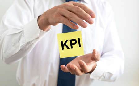 KPI acronym Key Performance Indicator word text inscription on paper sticker, businessman handの写真素材