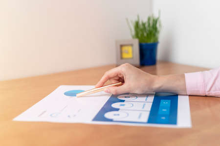 Strength Weaknesses Opportunities Threats Analysis Evaluation Strategy Concept. blue SWOT chart on office table with female hands with pen, marketing strategy, businessの写真素材