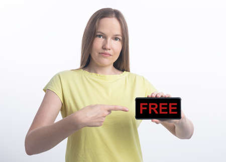 Free word inscription on black phone screen with young woman pointing at phone over white background, free trial periodの写真素材