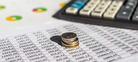Coins, chart and calculator as a symbol for exchange rates. financial concept, analyzing accounting, bannerの写真素材