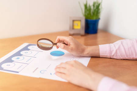 Strength Weaknesses Opportunities Threats Analysis Evaluation Strategy Concept. blue SWOT chart on office table with female hands with pen, marketing strategy, businessの写真素材