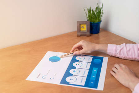 Strength Weaknesses Opportunities Threats Analysis Evaluation Strategy Concept. blue SWOT chart on office table with female hands with pen, marketing strategy, businessの写真素材