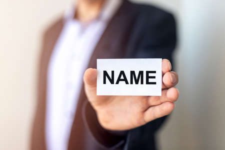 NAME word on paper in male hand in suit, brand and naming conceptの写真素材