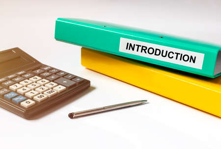 Introduction Word on folder on office table with calculator, intoduction financial conceptの写真素材