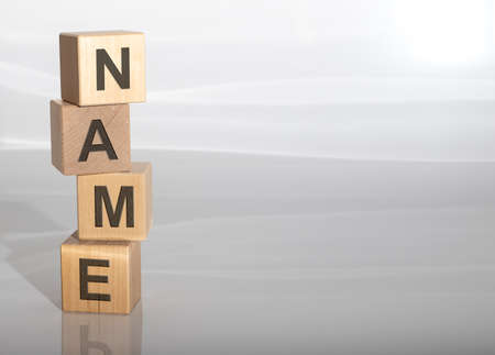word name on wooden cubes, letters on gray white background with copy space, branding and naming conceptの写真素材