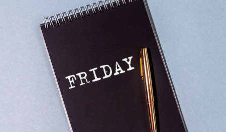 Friday word inscription on black notebook on office table, flatlayの写真素材