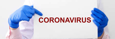 Concept of coronavirus. 2019-nCoV inscription word on white paper in doctor hands in protective...