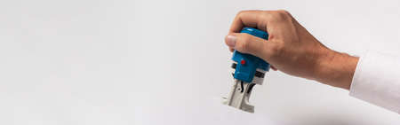 Businessman hand hold office stamp over white background. copy space for text, bannerの写真素材