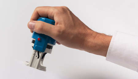Businessman hand hold office stamp over white background.の写真素材