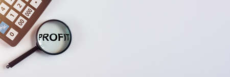 Profit word through magnifying glass on white table with calculator, banner, flatly, copy space for...