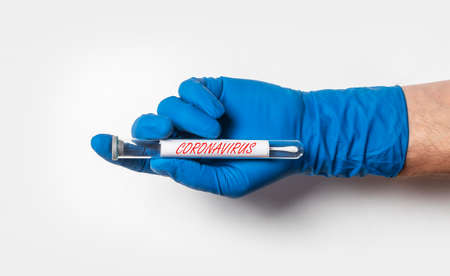 Doctor hand in glove holding test tube with for 2019-nCoV coronavirus. Covid tube over white...