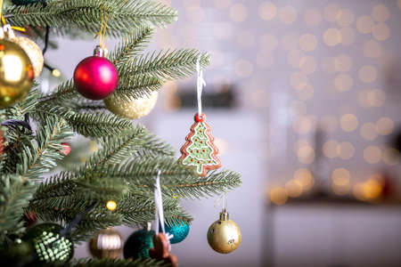 Close up view of beautiful firtree branches with baubles or balls, xmas ornaments and toys and...