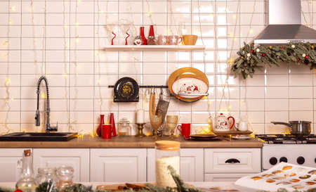 Decorated kitchen interior design with furniture in red and white with warm lights.の写真素材