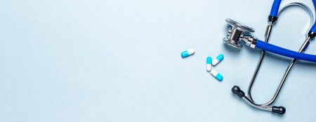 Medical blue banner with stethoscope, pills, capsules and place for text or copy space. Bannerの写真素材