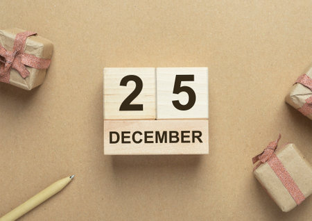 25 December date on woden calendar over craft eco backgound. Eco Christmas concept.