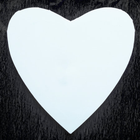 Mock up of white heart on vintage black paper background.の写真素材