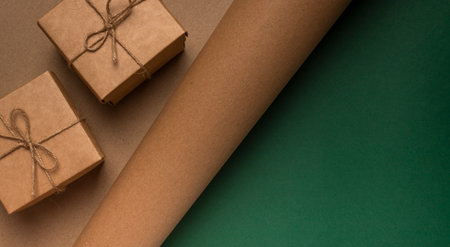 Eco background of craft cardboard texture with two gift boxes and green backdrop.の写真素材