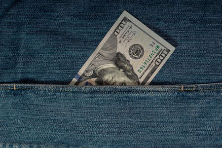 Hundred dollars in pocket with pen. Money and cash.
