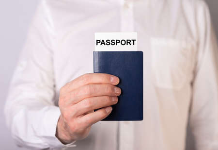Male hand holding passport, close up.の写真素材