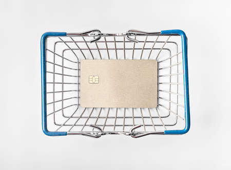 Golden bank card in shopping basket. Top viewの写真素材