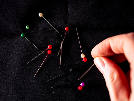 Tailors pins on black background, top view.の写真素材